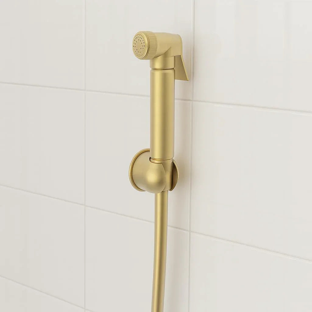 Gold handheld shower head on a tiled bathroom wall