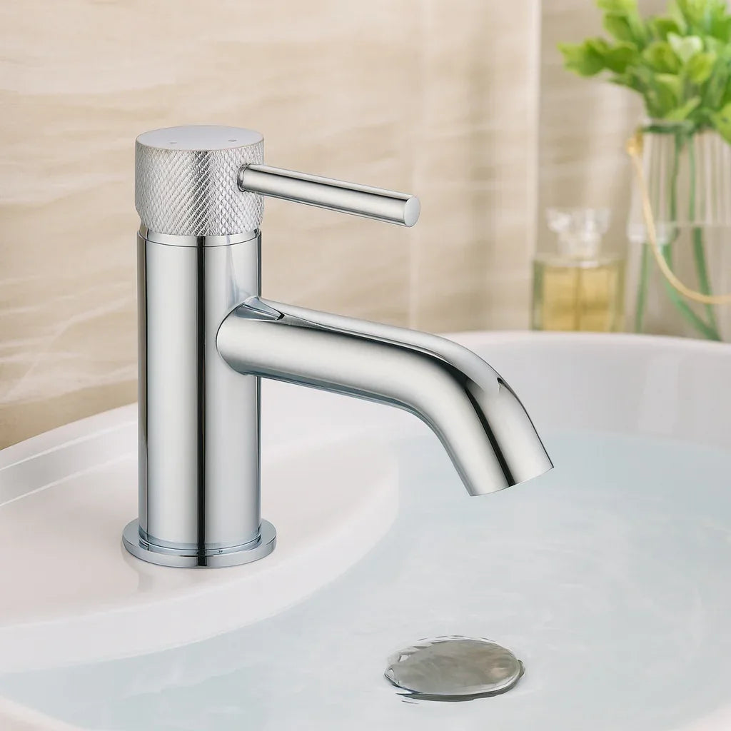Chrome bathroom faucet on a sink with a blurred background
