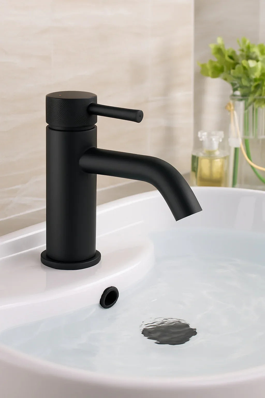 Black faucet on a white sink with a blurred background