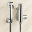Chrome handheld shower head and wall-mounted shower control valve on a beige tiled wall.