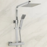 Chrome shower system with rain shower head and handheld shower on a light background