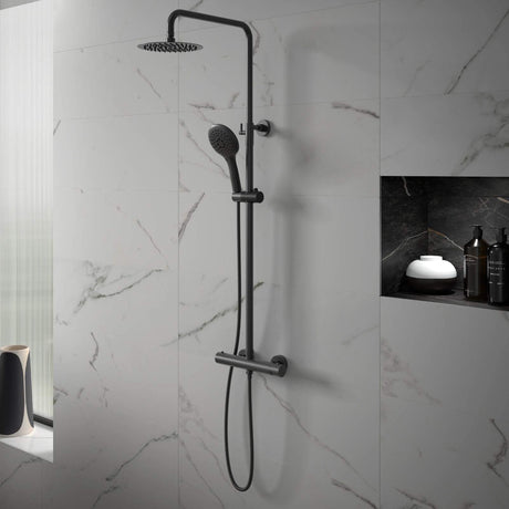 Black shower head and hose mounted on a marble wall
