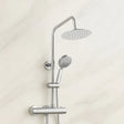 Chrome shower set with rain shower head and handheld shower on a light beige wall.
