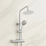 Chrome shower set with rain shower head and handheld shower on a light beige wall.