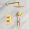 Gold shower set with shower head and control valve on a marble background