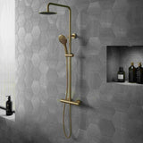 Bathroom with hexagonal gray tiles, gold shower fixtures, and shelves with bottles.