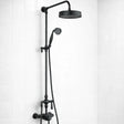 Black shower head and hose on a white tiled wall
