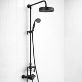 Black shower head and hose on a white tiled wall