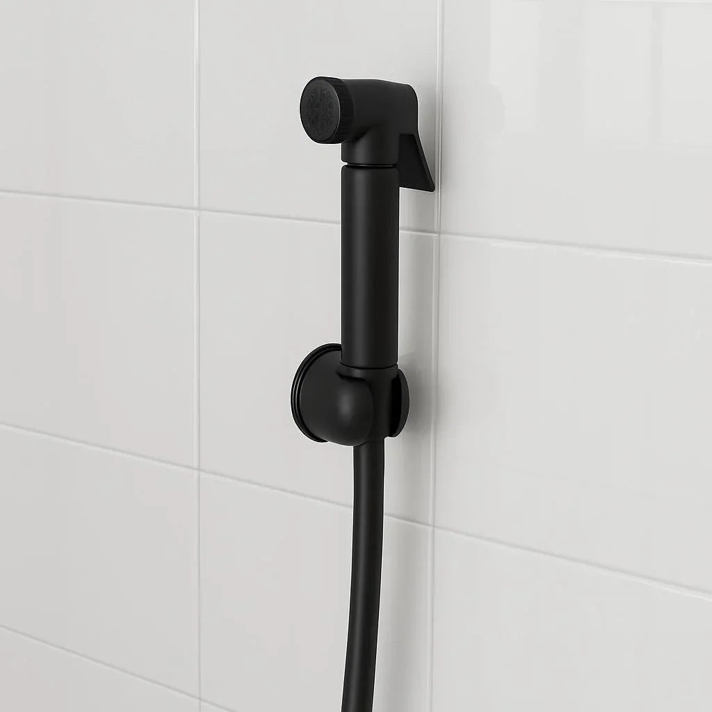 Black shower head and hose against a white tiled wall