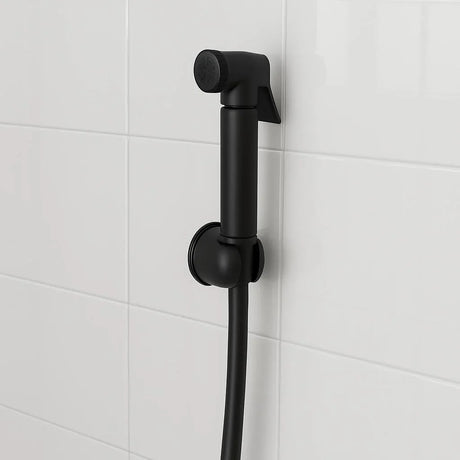 Black shower head and hose against a white tiled wall
