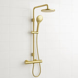 Gold shower set with handheld shower head and wall-mounted showerhead on a white tiled wall.