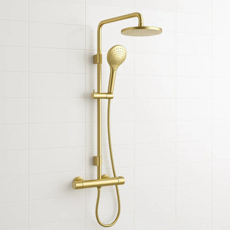 Gold shower set with handheld shower head and wall-mounted showerhead on a white tiled wall.