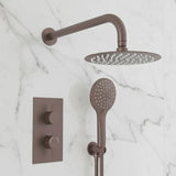 Bronze shower head and control panel on a marble wall