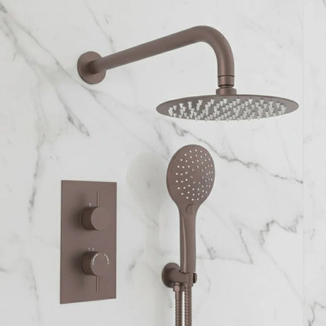Bronze shower head and control panel on a marble wall