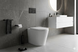Modern bathroom with a toilet, sink, and towel rack.