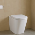 White toilet against a beige tiled wall