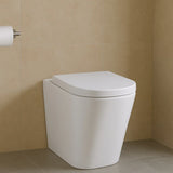 White toilet against a beige tiled wall
