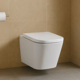 Wall-mounted white toilet against a beige tiled wall