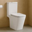 White toilet against a beige tiled wall