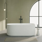 Modern white freestanding bathtub in a stylish bathroom with a large window.