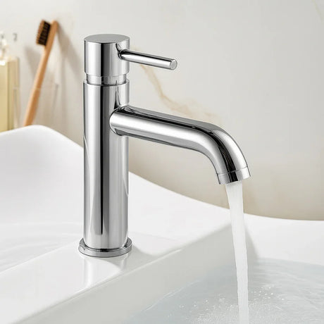Chrome faucet on a white sink with water flowing, bathroom setting.