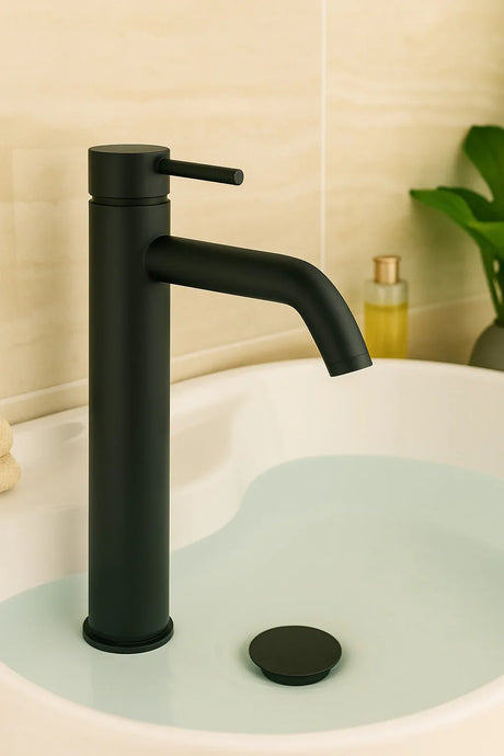 Black faucet on a sink with a neutral background