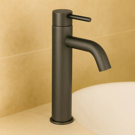 Black faucet against a beige tiled wall