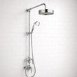 Chrome shower head and hose against a white tiled wall