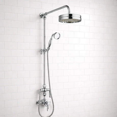 Chrome shower head and hose against a white tiled wall