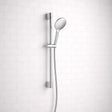 Chrome shower head and hose against a white tiled wall