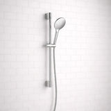 Chrome shower head and hose against a white tiled wall