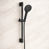 Black shower head with handheld shower on a light beige background