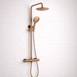 Bronze shower set with multiple nozzles on a white tiled wall background