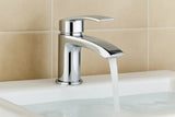 Chrome faucet with running water on a beige tiled wall background