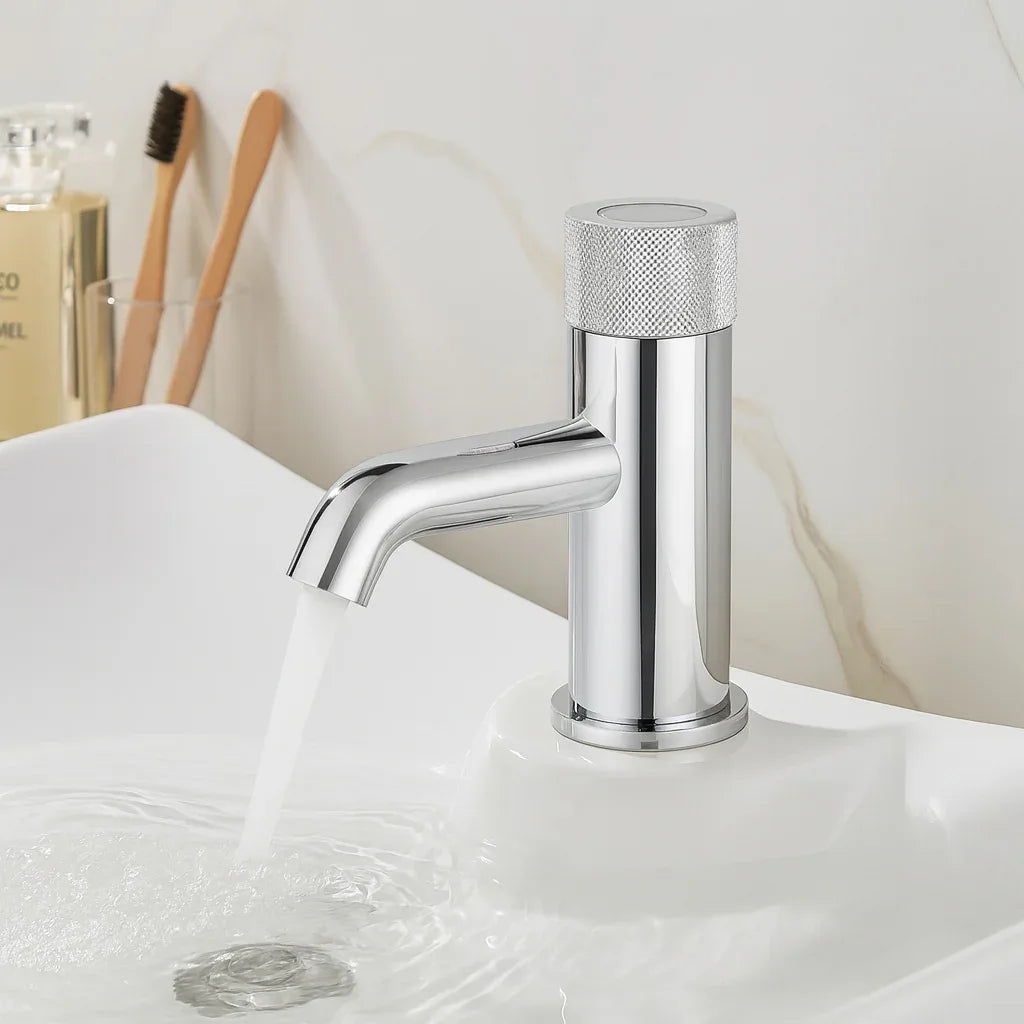 Chrome faucet on a bathroom sink with a blurred background