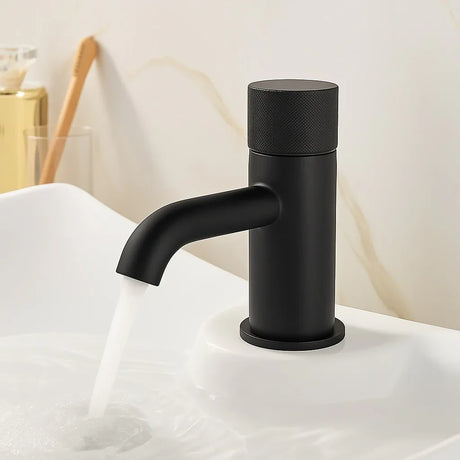 Black faucet on a white sink with a neutral background