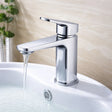 Chrome faucet on a white sink with water flowing, against a neutral background.