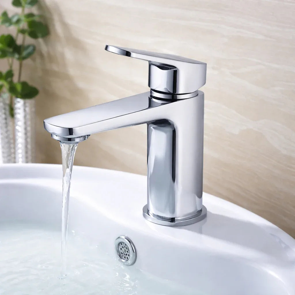 Chrome faucet on a white sink with water flowing, against a neutral background.