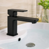 Black faucet on a white sink with a blurred background