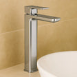 Chrome bathroom faucet on a beige tiled wall