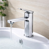 Chrome faucet on a sink with water flowing, against a neutral background
